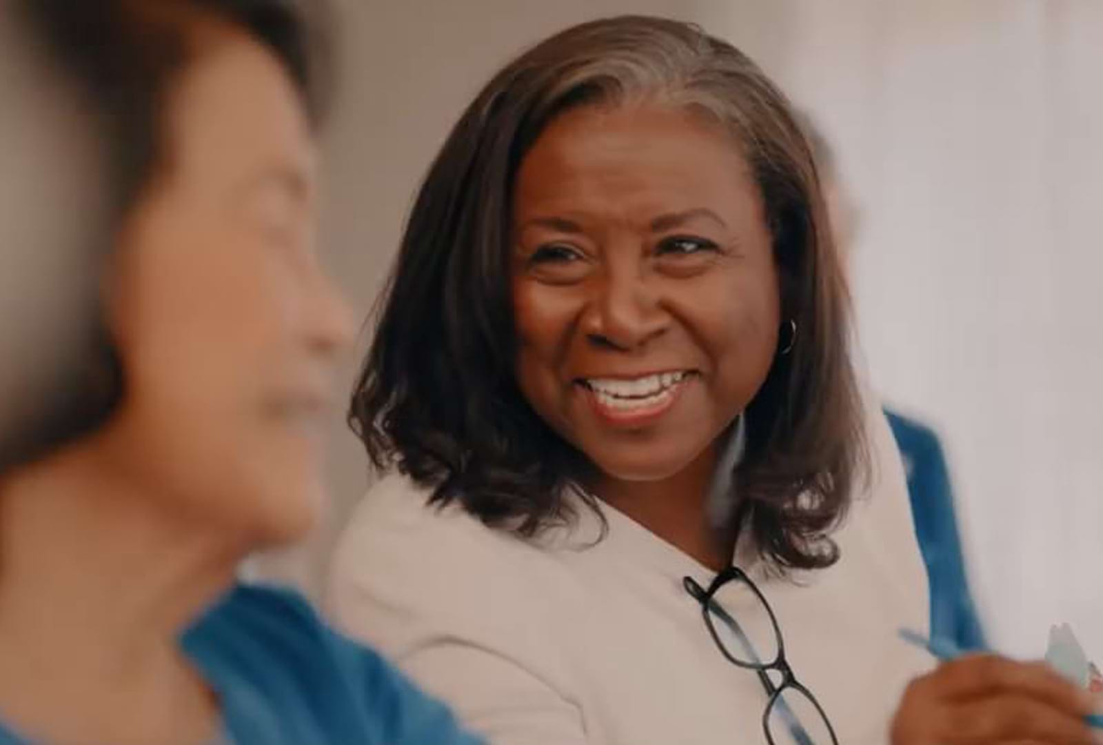 a woman smiling and talking
